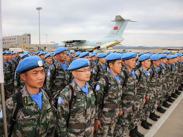 Chinese soldiers wearing the blue beret of the UN.