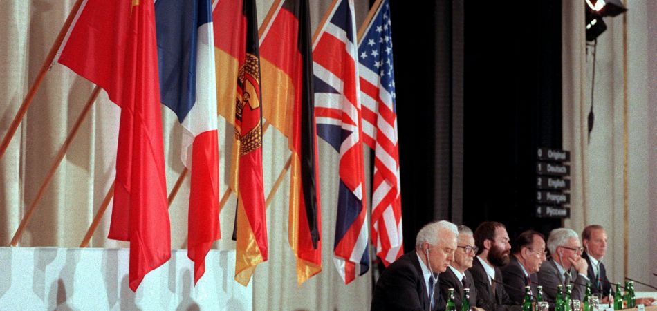 The representatives of the Two Plus Four countries in front of their flags. The representatives of the Two Plus Four countries in front of their flags.