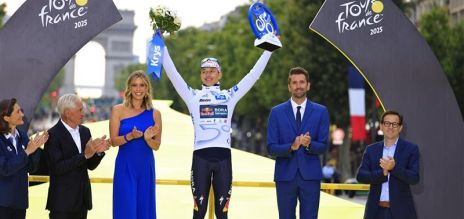 The winners of the Tour de France stand on the podium. 