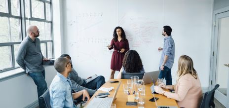 People sitting and standing in an office.