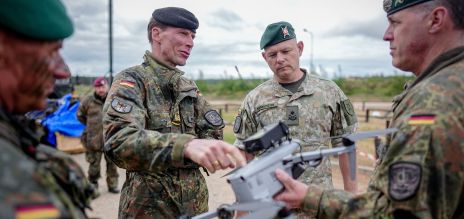Soldiers holding an aerial drone in their hands