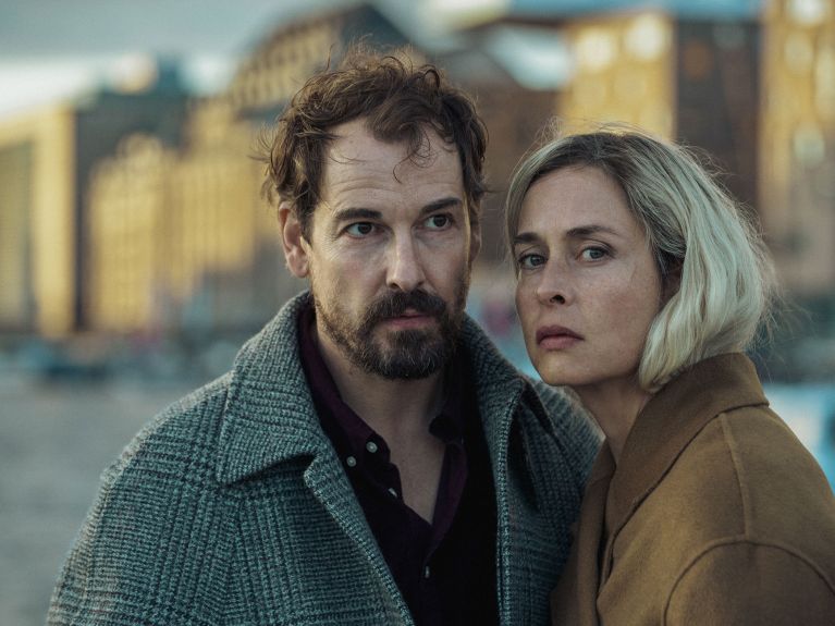 A man with a beard and a peroxide-blond woman, both aged around 50