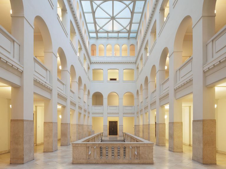 a large atrium featuring pillars and a glass roof