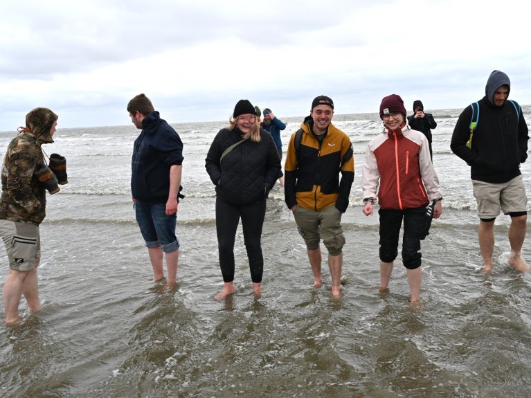 Young people paddle in the sea