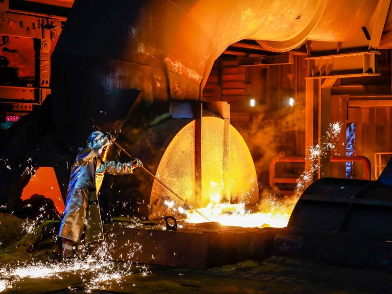 A steel worker in a protective suit at the blast furnace A steel worker in a protective suit at the blast furnace