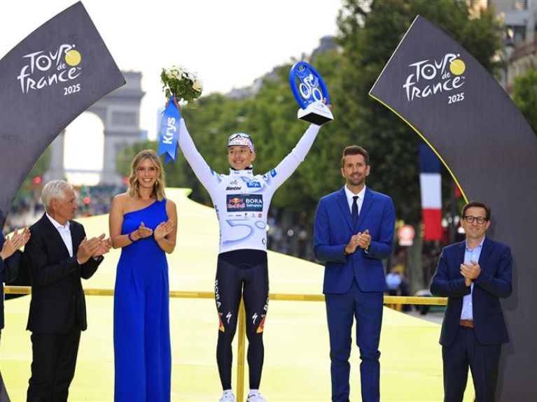 The winners of the Tour de France stand on the podium. The winners of the Tour de France stand on the podium.