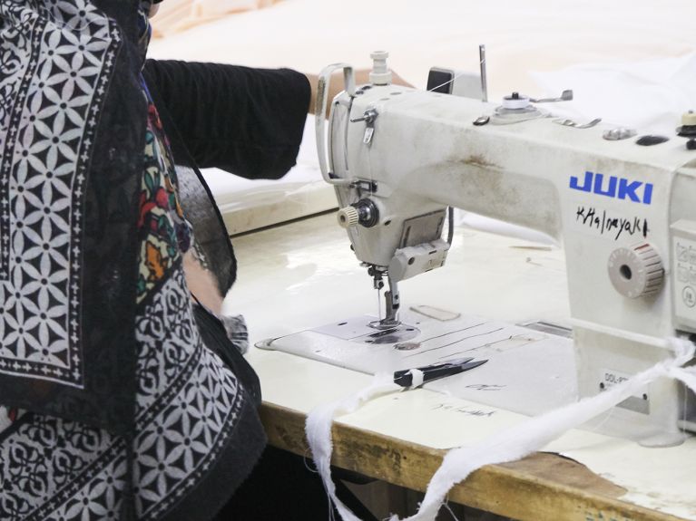 A seamstress at a supplier in Pakistan