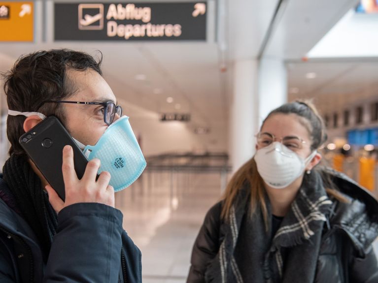 Reisende am Flughafen telefonieren