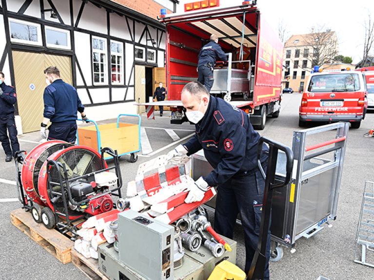 Firefighters unload equipment collected and donated by various fire brigades in the country at the Alte Kelter in Fellbach.