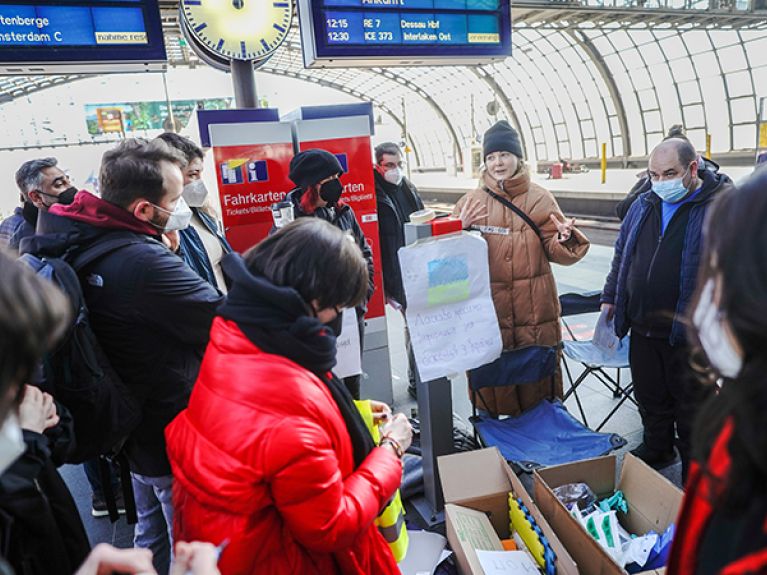 In Berlin, helpers have their names and the languages they speak pasted on their chests. 