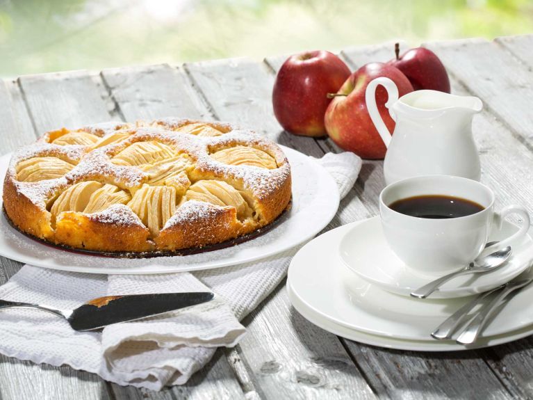 Apple pie, coffee cup and plate, apples on wood Apple pie, coffee cup and plate, apples on wood