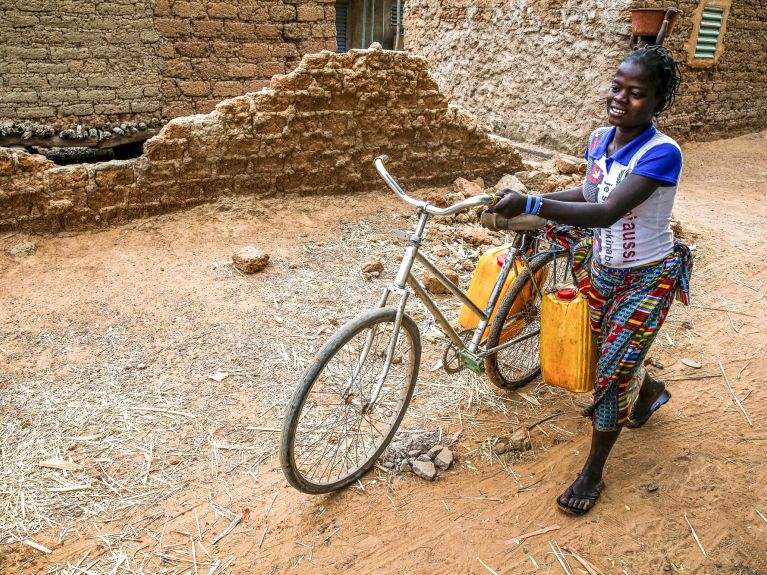 Girl fetching water near Ouahigouya, Burkina Faso Girl fetching water near Ouahigouya, Burkina Faso