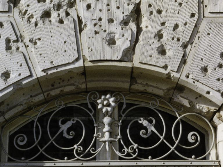   The bullet holes on the facade of Villa Parey were preserved for commemorative purposes during renovation work.