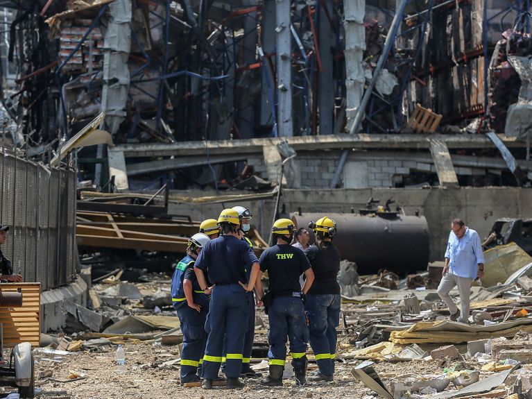 Discussing the situation amongst the rubble.