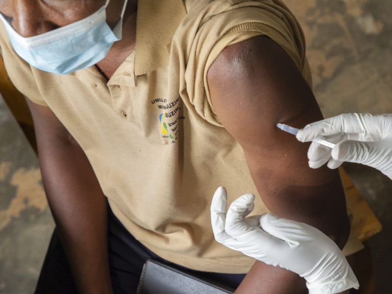 A Rwandan health worker is vaccinated. 