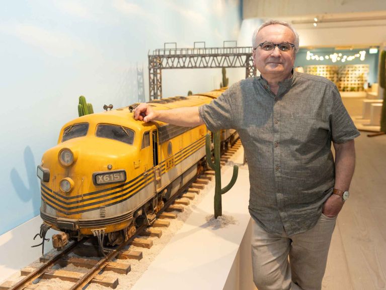 Simon Weisse with the model of a train from “Asteroid City”