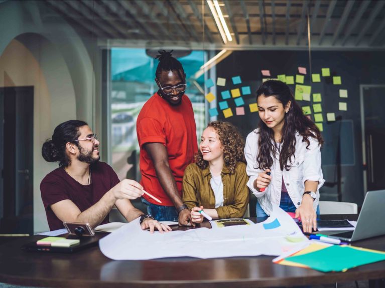 Two young women and two young men have a business meeting 