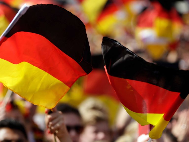 Football fans waving the German flag.