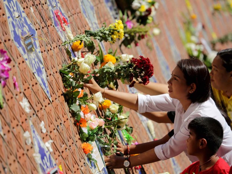 Mourners at a tsunami memorial park in Thailand Mourners at a tsunami memorial park in Thailand