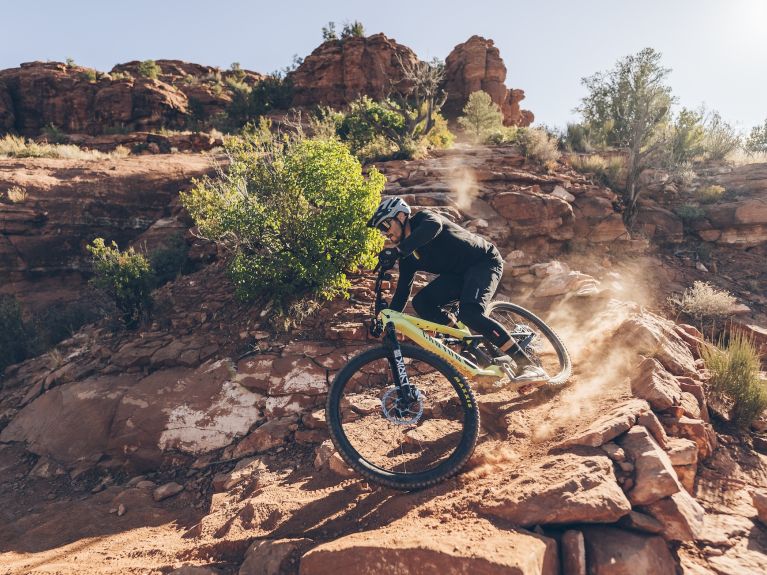 A mountain biker cycling downhill in the mountains 