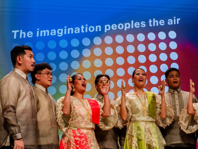 Singers from the Philippines perform at the announcement of the Guest of Honour 
