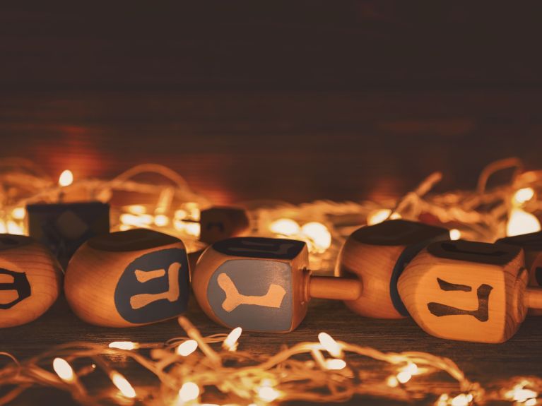 A dreidel with Hebrew characters – many children play the popular game as part of the celebrations. 