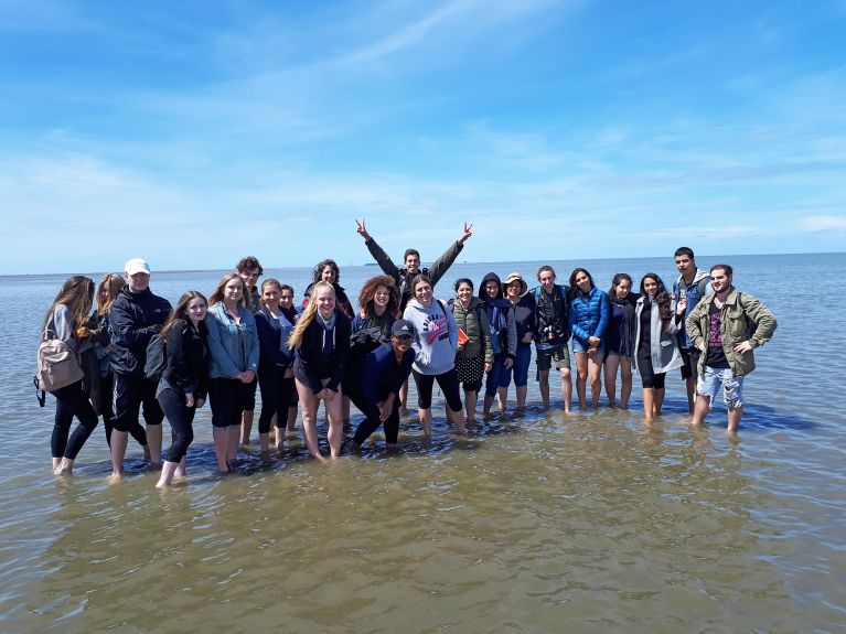 Exchange of contrasts: Israeli pupils hiking on the mud flats...