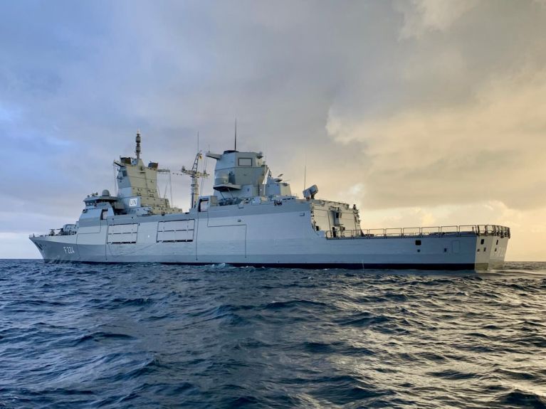 A ship bearing the letters “UN” is sailing across the sea. 