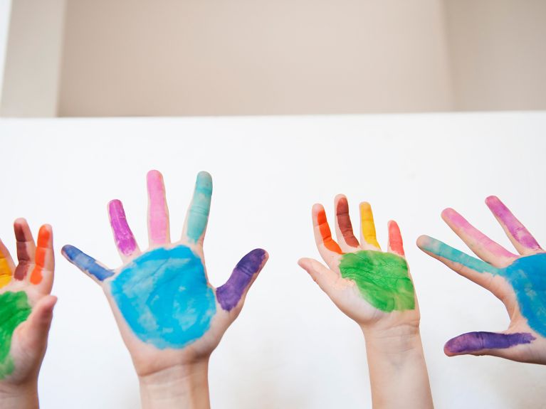 School is fun: Children raising their hands