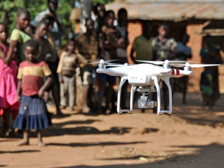 A drone takes off in a Malawian village