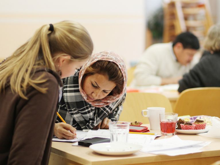 Refugees and helpers at a meeting centre  in Leipzig