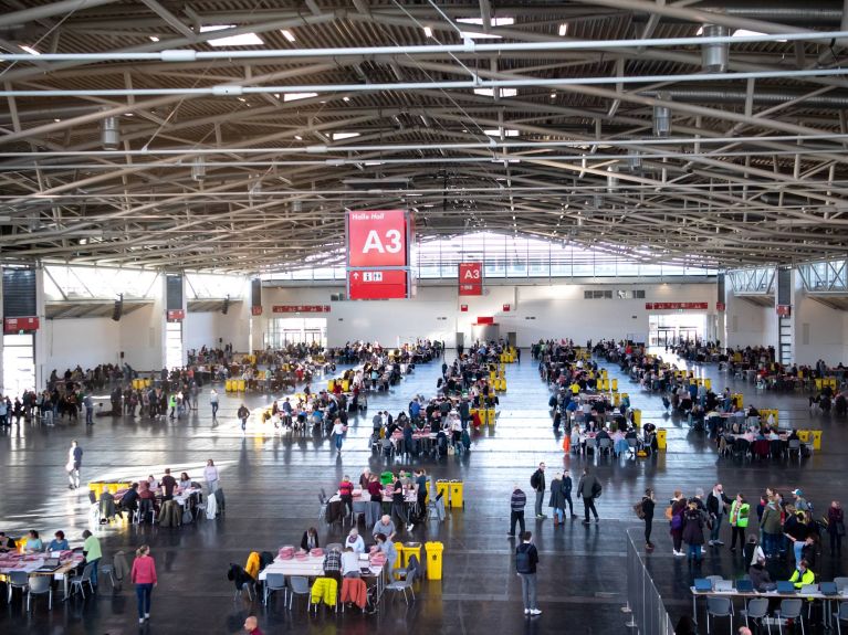 Postal ballots being counted in an exhibition hall in 2020.