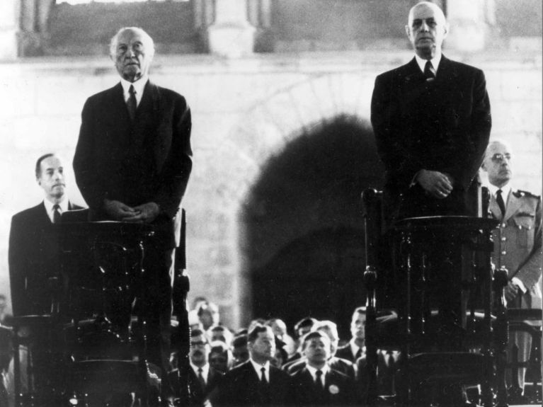 1962: De Gaulle and Adenauer celebrate a service of reconciliation at Reims Cathedral. The cathedral had been badly damaged by German troops during the First World War. 