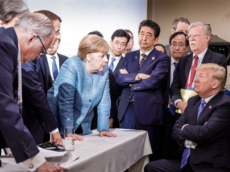 أنجيلا ميركل مع دونالد ترامب، خلال قمة السبعة الكبار G7 في كندا 2018. 