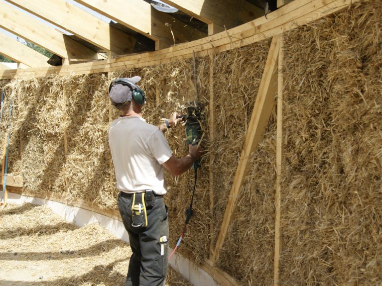Putting the final touches on the straw bales.