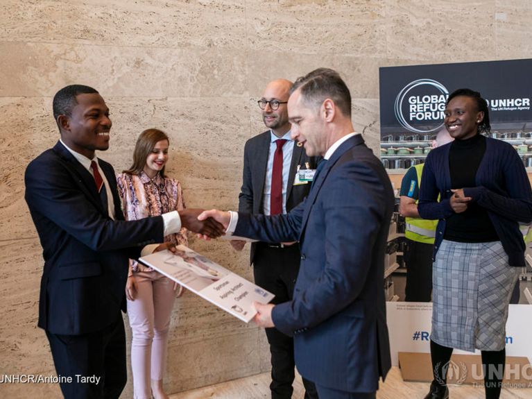 Minister spraw zagranicznych Heiko Maas na Światowym Forum Uchodźców w Genewie, w tle Foni Joyce Vuni