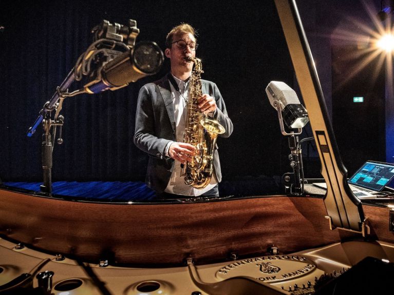 Sebastian Trump is interacting with an AI-controlled grand piano  Sebastian Trump is interacting with an AI-controlled grand piano