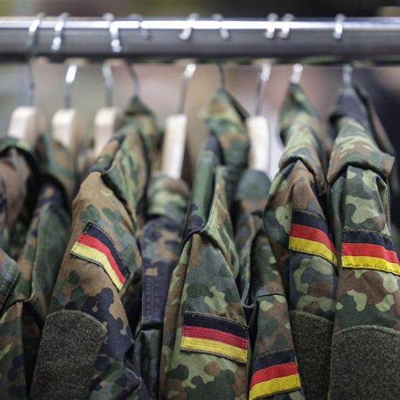 Bundeswehrjacken hängen an einem Kleiderständer. 
