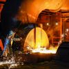 A steel worker in a protective suit at the blast furnace