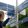 Studentin vor Hinweisschild an Universität