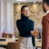 Business partners shaking hands after the meeting, male and female.