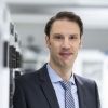Prof. Dr. Björn Ommer,  ein Mann Mitte 40, kurze dunkle Haare,  im Anzug  